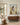 Arms of Mercy Christian wall art by Gabriel Heaton in a natural wood float frame above a walnut console in a warm neutral living room