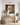 He Is Risen Christian wall art by Gabriel Heaton in a natural wood float frame above a console table on a bright paneled wall