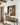 He Is Risen Christian wall art by Gabriel Heaton in a natural wood float frame above a rustic console table on a white shiplap wall